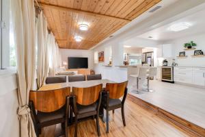 a kitchen and living room with a table and chairs at Pompano Beach Hideaway with Fenced Yard & BBQ in Pompano Beach
