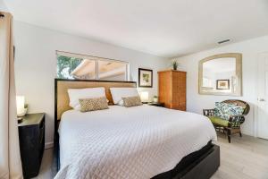 a bedroom with a large bed and a mirror at Pompano Beach Hideaway with Fenced Yard & BBQ in Pompano Beach