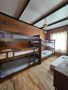 two bunk beds in a room with a brick wall at Rancho Cata Vento in Santa Clara dʼOeste +40 photos