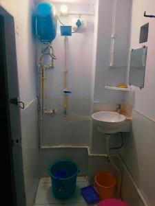 a small bathroom with a sink and a shower at Kanchan Lata Homestay in Banāras Cantonment