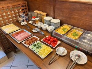 a table with many different types of food on it at Corvin Hotel in Győr