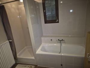 a white bath tub in a bathroom with a shower at Ferienhaus Sofia in Cochem +15 photos