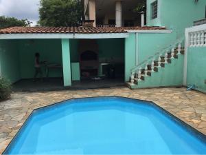 a swimming pool in front of a house at The grey house centrally located in Campinas