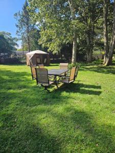 a picnic table with a tent in a field at Private Area & Access to Home, Rooms In Bayshore in Bay Shore