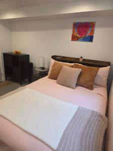 a bedroom with a large bed with a heart painting on the wall at Private Area & Access to Home, Rooms In Bayshore in Bay Shore