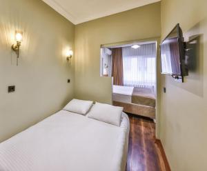 a small room with a bed and a tv at Peaceful Apartment Near Galata in Istanbul