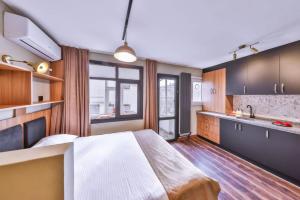 a bedroom with a large bed and a kitchen at Peaceful Apartment Near Galata in Istanbul