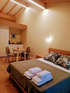 a bedroom with two beds and a table with chairs at Grandmother Custódia's House Gerês in Campo do Gerês