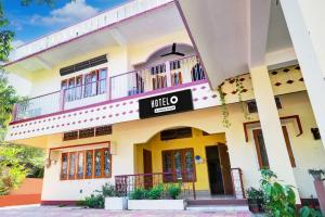 a building with a sign that reads nikolao at Hotel O Modern Home in Guwahati