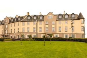 a large building with a lawn in front of it at Portrush Atlantic Hotel in Portrush