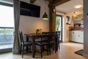 a kitchen and dining room with a table and chairs at Sümeg Horizon in Sümeg +48 photos