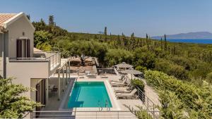 a villa with a swimming pool and a view of the ocean at Ruggero by Vintage Travel in Psilithriás