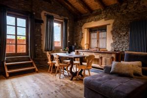 a living room with a table and chairs and a couch at Brieis Relais Alpino in Marmora +64 photos