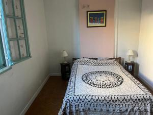 a bedroom with a bed with a patterned blanket at Une chambre à louer dans une maison au centre ville Uzes in Uzès
