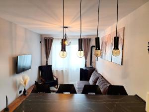 a living room with a table and a couch at Deer House - Self Check-in & Free Parking in Buşteni