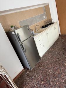 a kitchen with a stainless steel refrigerator and a sink at לרניקה - יחידות אירוח in Qiryat Shemona