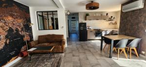 a kitchen and a living room with a couch and a table at La Solentina in Reynès