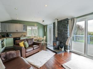 a living room with a couch and a fireplace at Harbour Lights in Holyhead