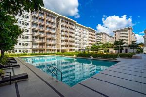 a large apartment building with a large swimming pool at 1BR Condo with Free Parking at SMDC Trees Residences, Fairview Quezon City in Manila
