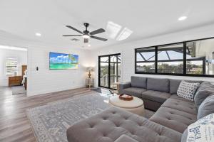 a living room with a couch and a ceiling fan at Club Red in Sanibel