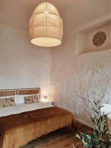 a bedroom with a bed and a large light fixture at OroCasa7 in La Orotava
