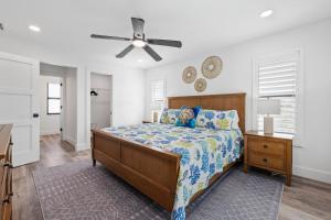 a bedroom with a bed and a ceiling fan at Club Red in Sanibel +45 photos