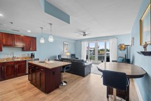 a kitchen and living room with a couch and a table at Laketown Wharf 135 in Panama City Beach