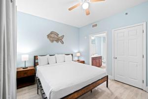 a bedroom with a bed with a fish on the wall at Laketown Wharf 135 in Panama City Beach +34 photos