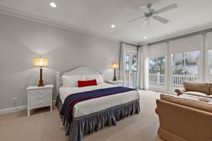 a white bedroom with a bed and a couch at Chiltren By The Sea in Edisto Island