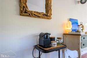 a microwave sitting on a table in a room at Casa Maria Sol- jardín I vistas al mar I 4 habitaciones I parking I BBQ in Cadaqués