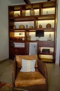 a wicker couch with a pillow in a living room at Beachfront house Private beach Pool 6 people in El Zapote +47 photos