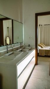 a bathroom with two sinks and a large mirror at Beachfront house Private beach Pool 6 people in El Zapote