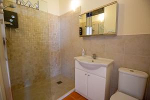 a bathroom with a sink and a toilet and a mirror at Nature's Lodge in Wolverley +30 photos