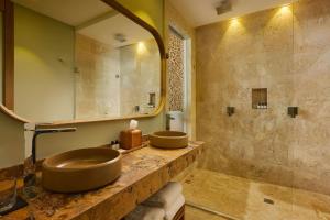 a bathroom with two sinks and a large mirror at The Brown, Guatape, Autograph Collection in Guatapé +103 photos