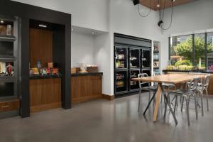 a dining room with a table and a bar at Aloft Hillsboro-Beaverton in Hillsboro