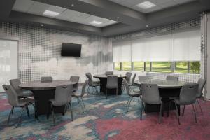 a conference room with tables and chairs and a tv at Aloft Hillsboro-Beaverton in Hillsboro +42 photos