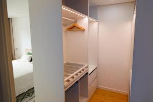 a walk in closet in a bedroom with a bed at In the heart of Ponte da Barca, cozy apartment in Ponte da Barca +24 photos