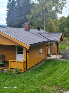 a house with a solar roof on top of it at Koselig hus i Valdres in Leira +43 photos