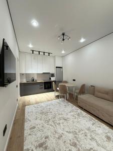 a living room with a couch and a table at Квартира in Astana