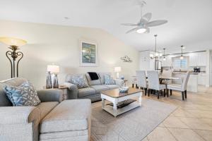 a living room with a couch and a table at Sandpiper Beach 205 in Ybel