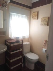 a bathroom with a toilet and a sink and a window at Rural Chalet in Arredondo in Arredondo