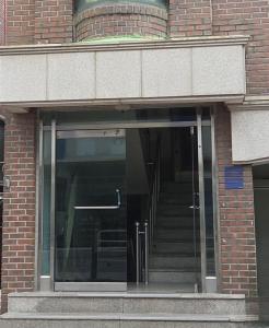 an open glass door of a brick building with stairs at 블레싱하우스 in Seoul