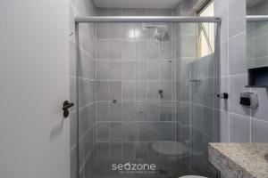 a shower with a glass door in a bathroom at Apto 1 Quarto a 650 m da Praia FAH0205 in Florianópolis +3 photos