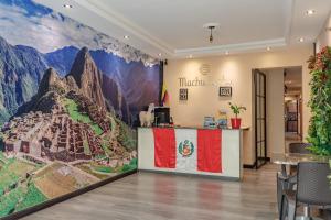 a restaurant with a mural of a mountain at Hostal Machu Picchu Medellin in Medellín