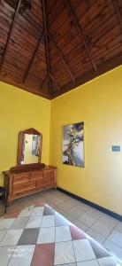a room with a mirror and a yellow wall at Casa Mariner Resort in Good Hope