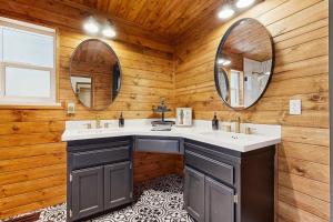 a bathroom with two sinks and two mirrors at Hot Tub, Game Room & Home Gym: Serene Arnold Gem in Arnold +27 photos