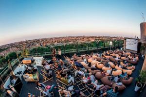 a crowd of people sitting on the roof of a building at Leonardo Hotel Amsterdam Rembrandtpark in Amsterdam
