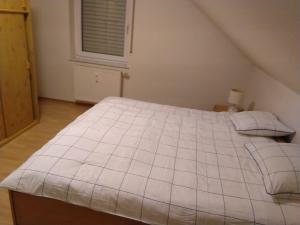 a large white bed in a room with a window at Appartement in Freudenburg