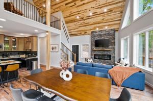 a living room with a blue couch and a table at New The Chaletresorthot Tubgameroomfirepit in Massanutten