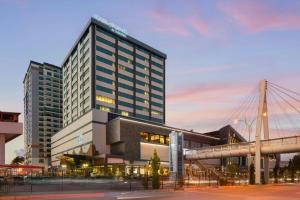 a tall building with a bridge in front of it at Four Points by Sheraton Elazig in Elazığ
